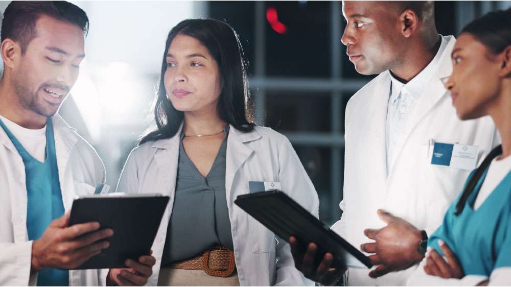 Doctors or researchers using digital tablets